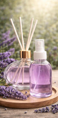 Casa Serena lavender diffuser set with home spray and reed diffuser sticks in glass bottles, surrounded by fresh lavender sprigs.